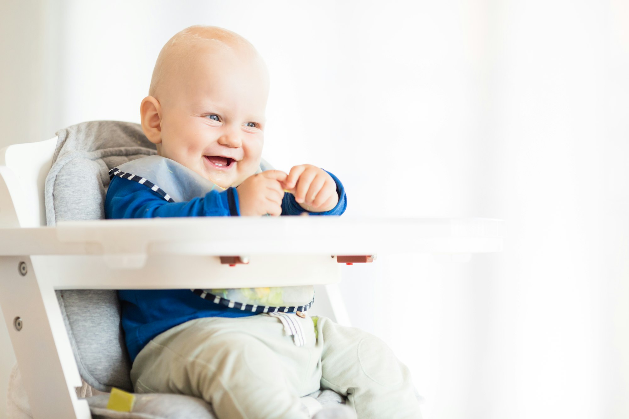 Baby boy eating with BLW method, baby led weaning