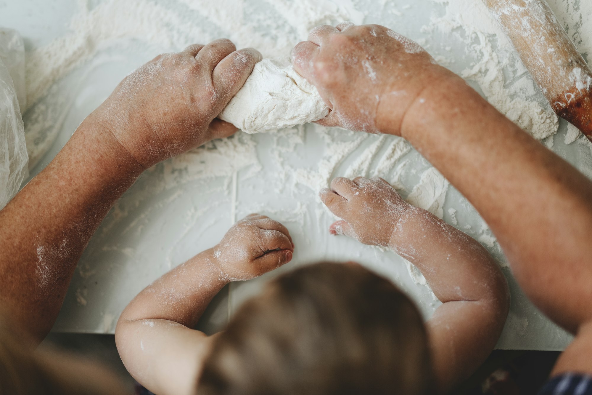 Grandmother teaching baby cooking home