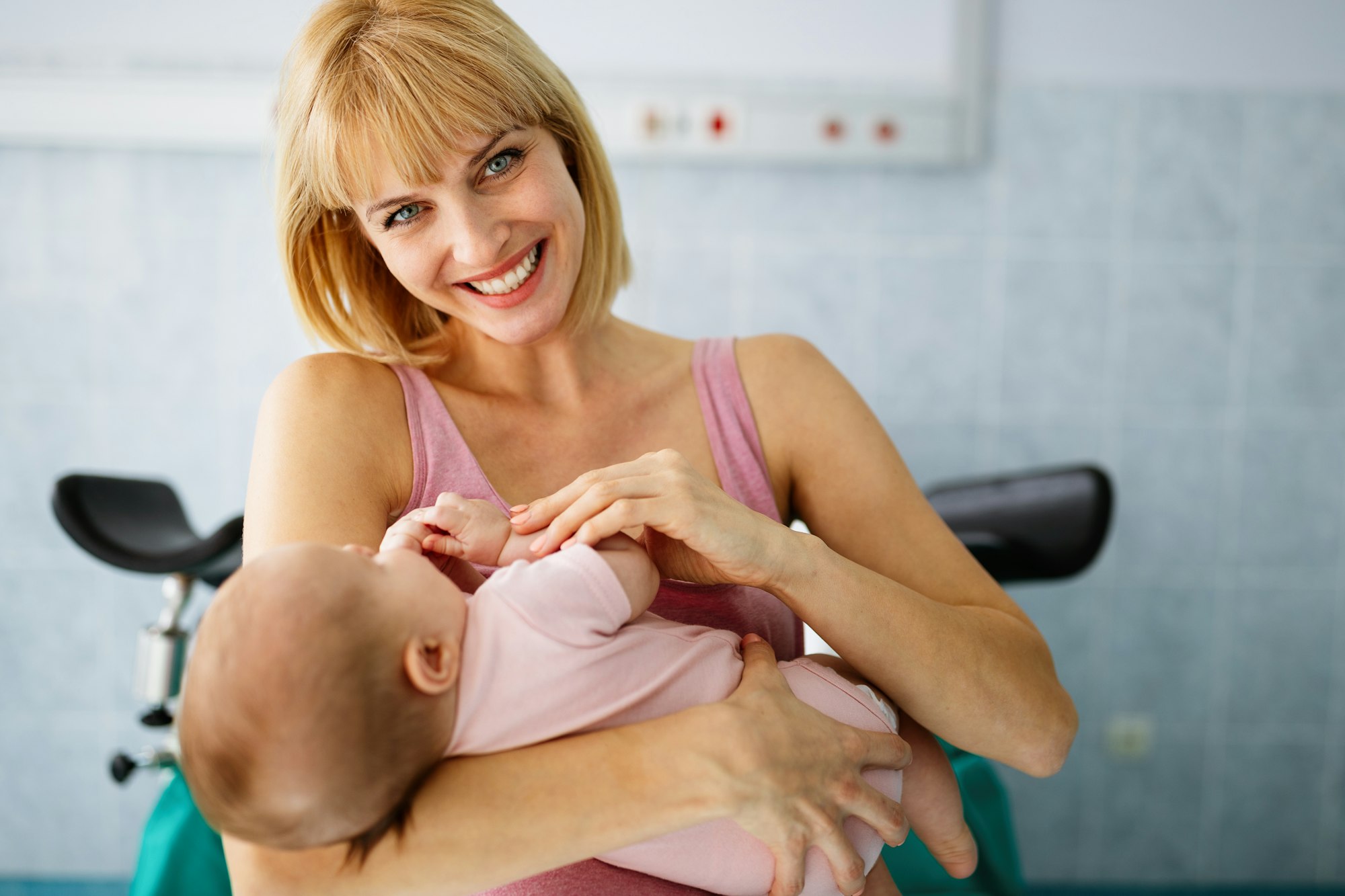 Happy mother with newborn baby in hospital