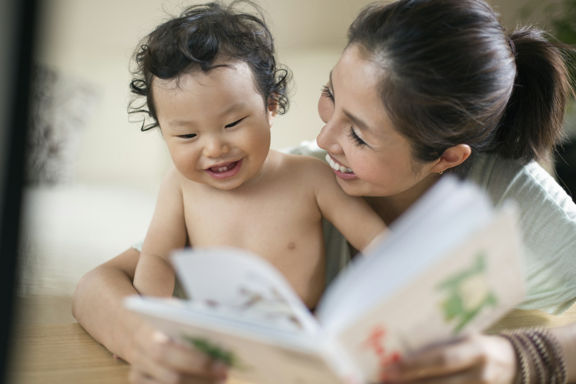 Mother reading to her baby boy.