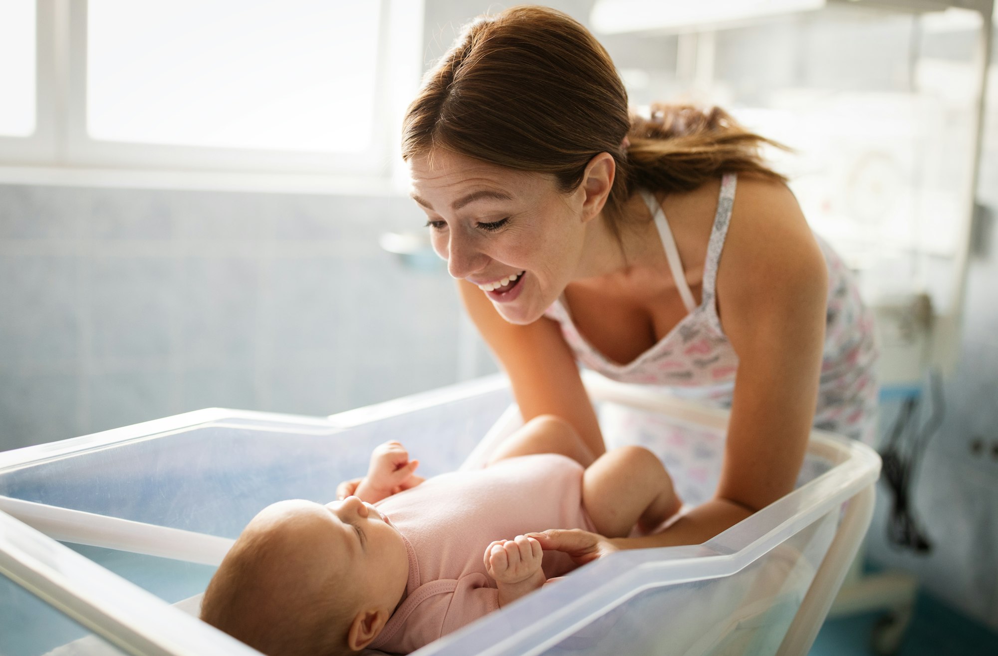 Portrait of beautiful young happy mother with baby